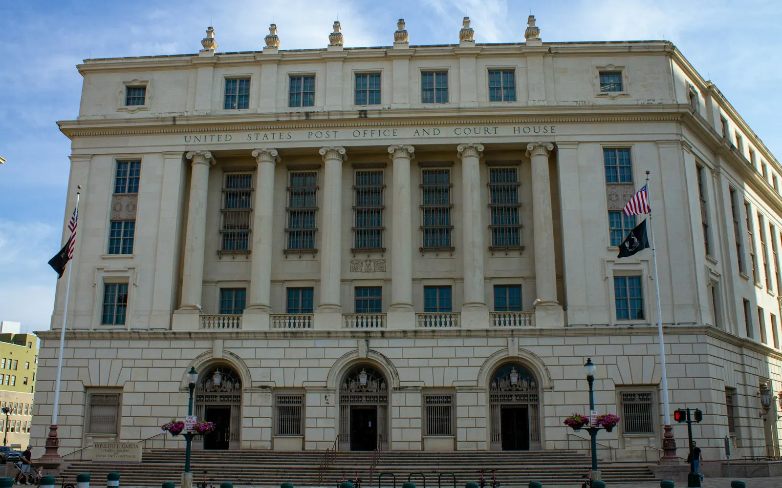 Stone courthouse building with flags flying out front