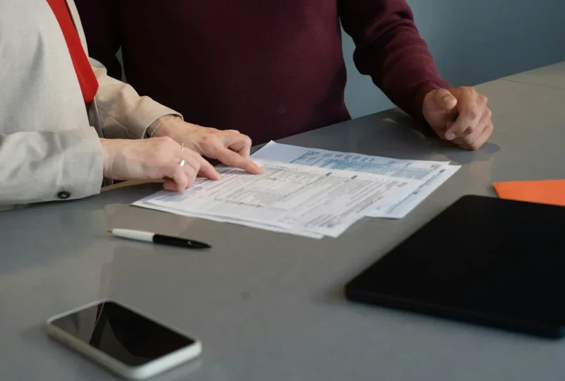 Two people reviewing paperwork together at a table