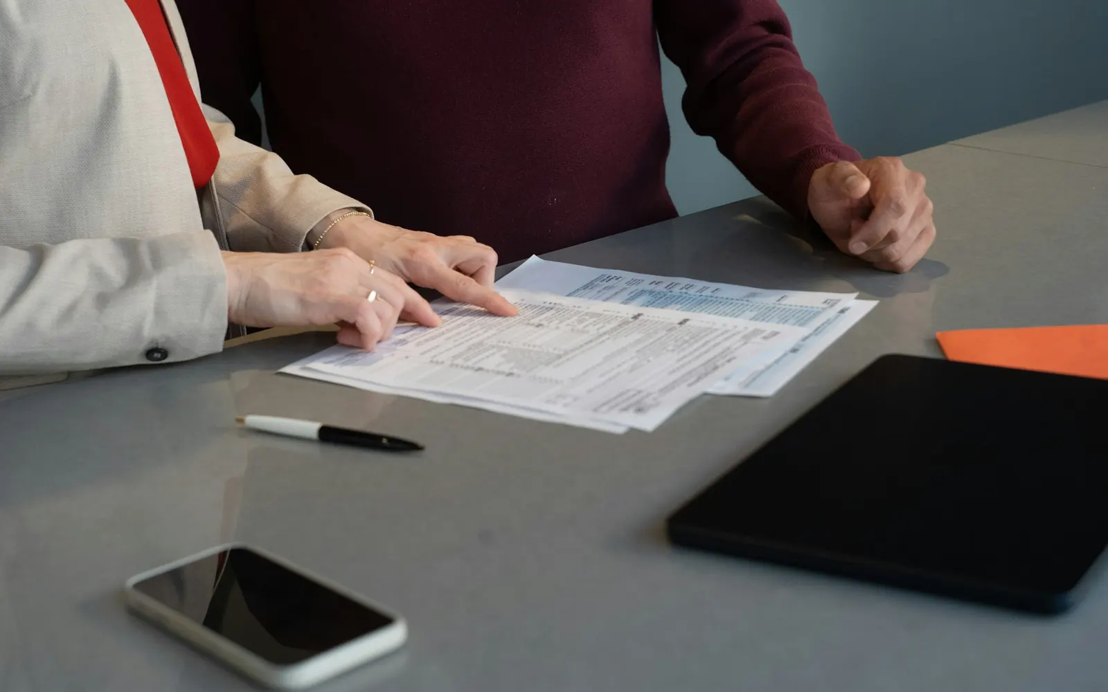 Two people reviewing paperwork together at a table