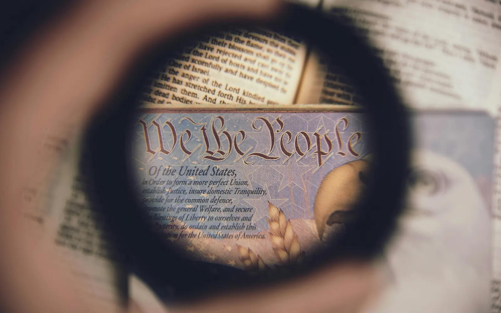 Magnifying glass over the words “We the People” in the U.S. Constitution